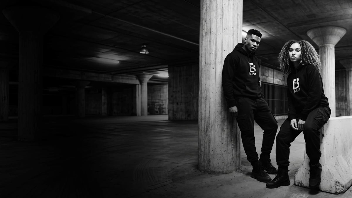 A couple wearing Blest black hoodies