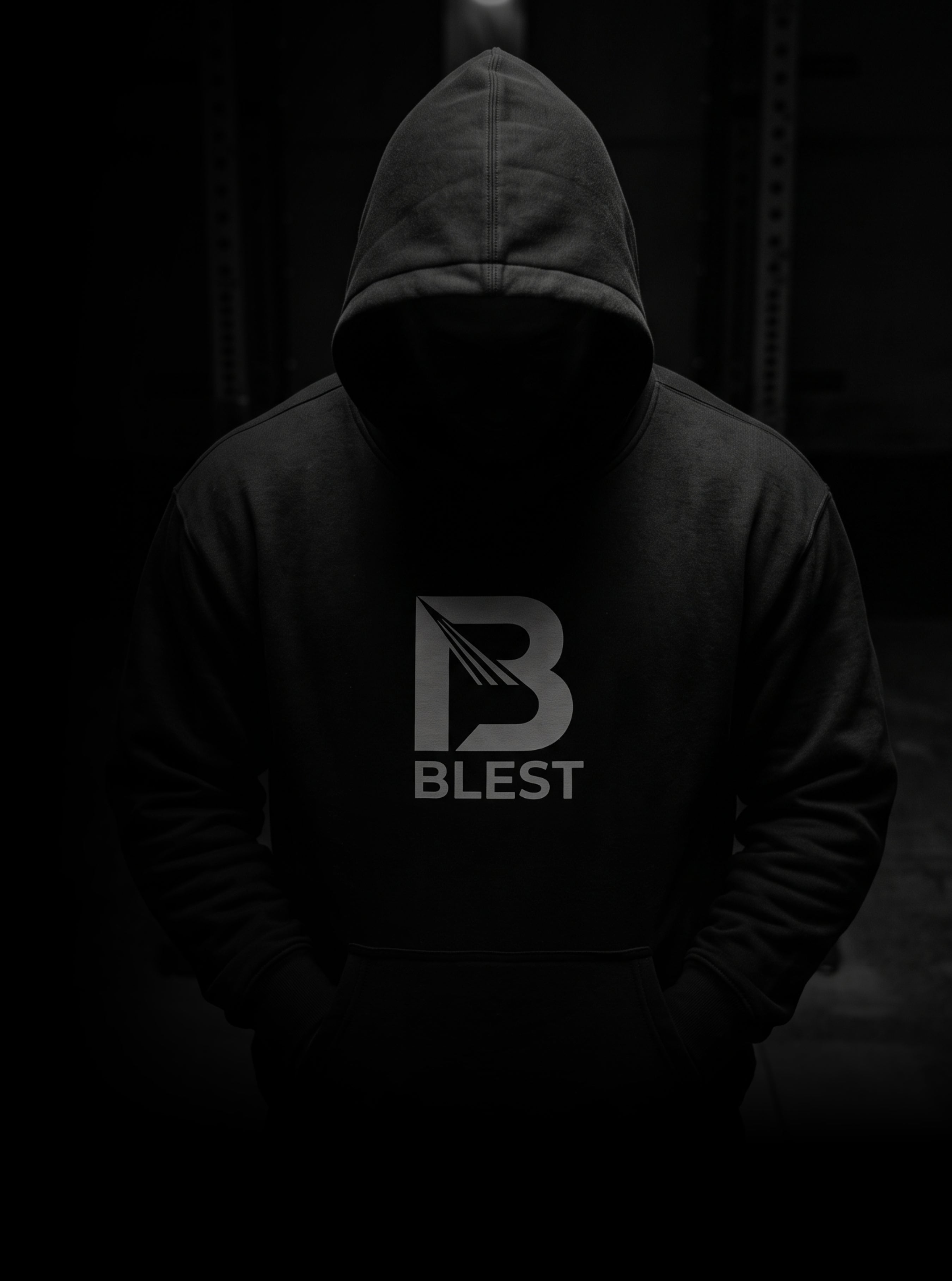 Man wearing a Blest hoodie on dark room