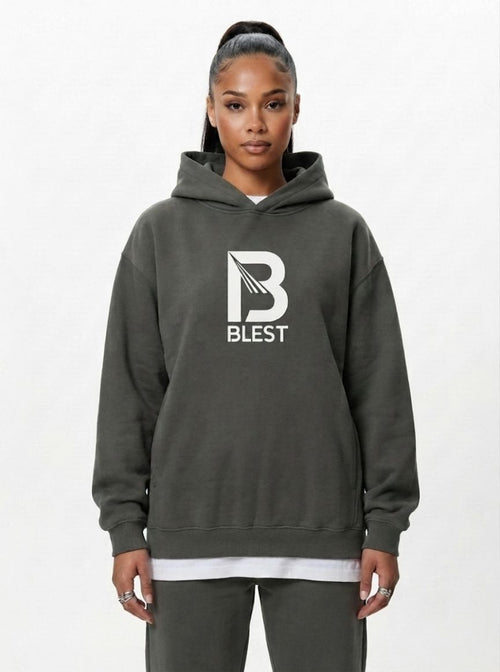 woman wearing the Blest grey pullover hoodie with white B Blest logo