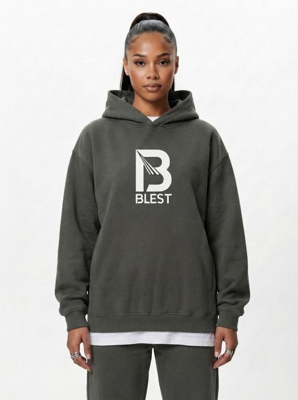 woman wearing the Blest grey pullover hoodie with white B Blest logo